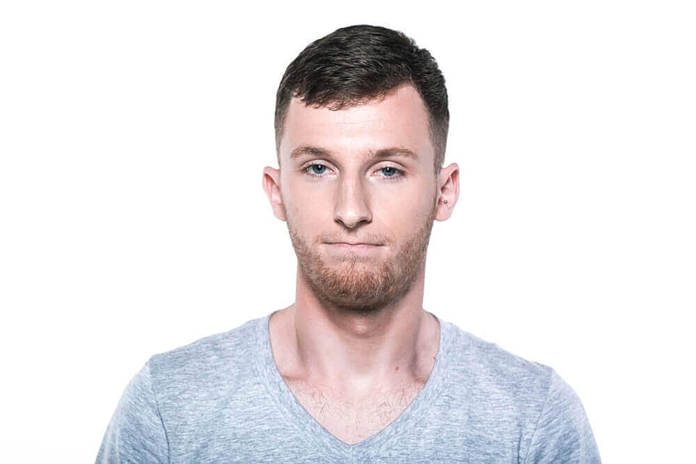 Man with short hair and gray shirt.