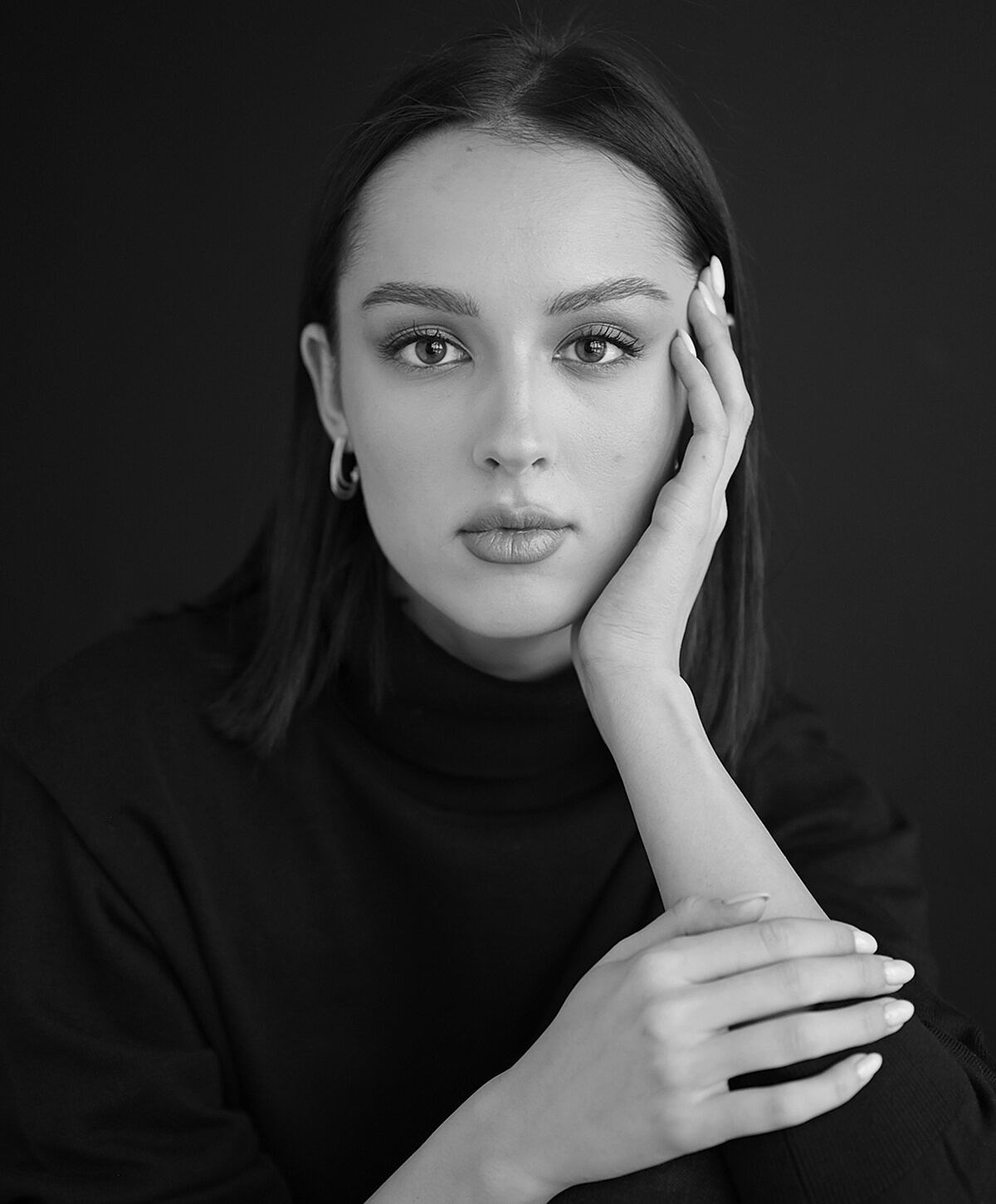 Black and white portrait of a thoughtful woman.