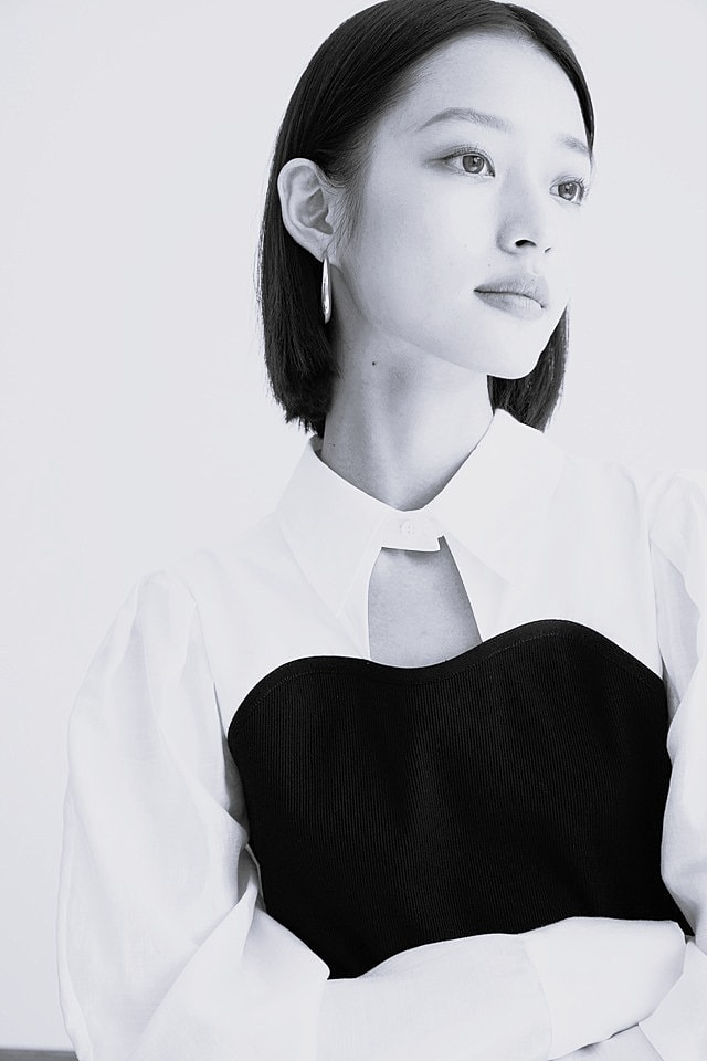 Model wearing a stylish beige fishnet bikini.