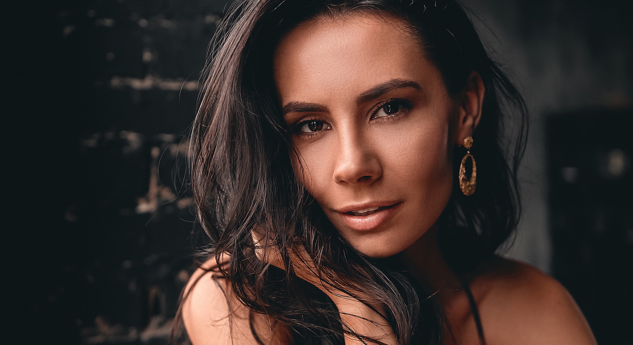 Woman with long hair and elegant earrings.