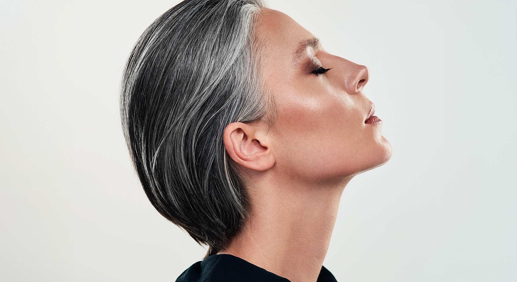 Profile of a woman with short gray hair.
