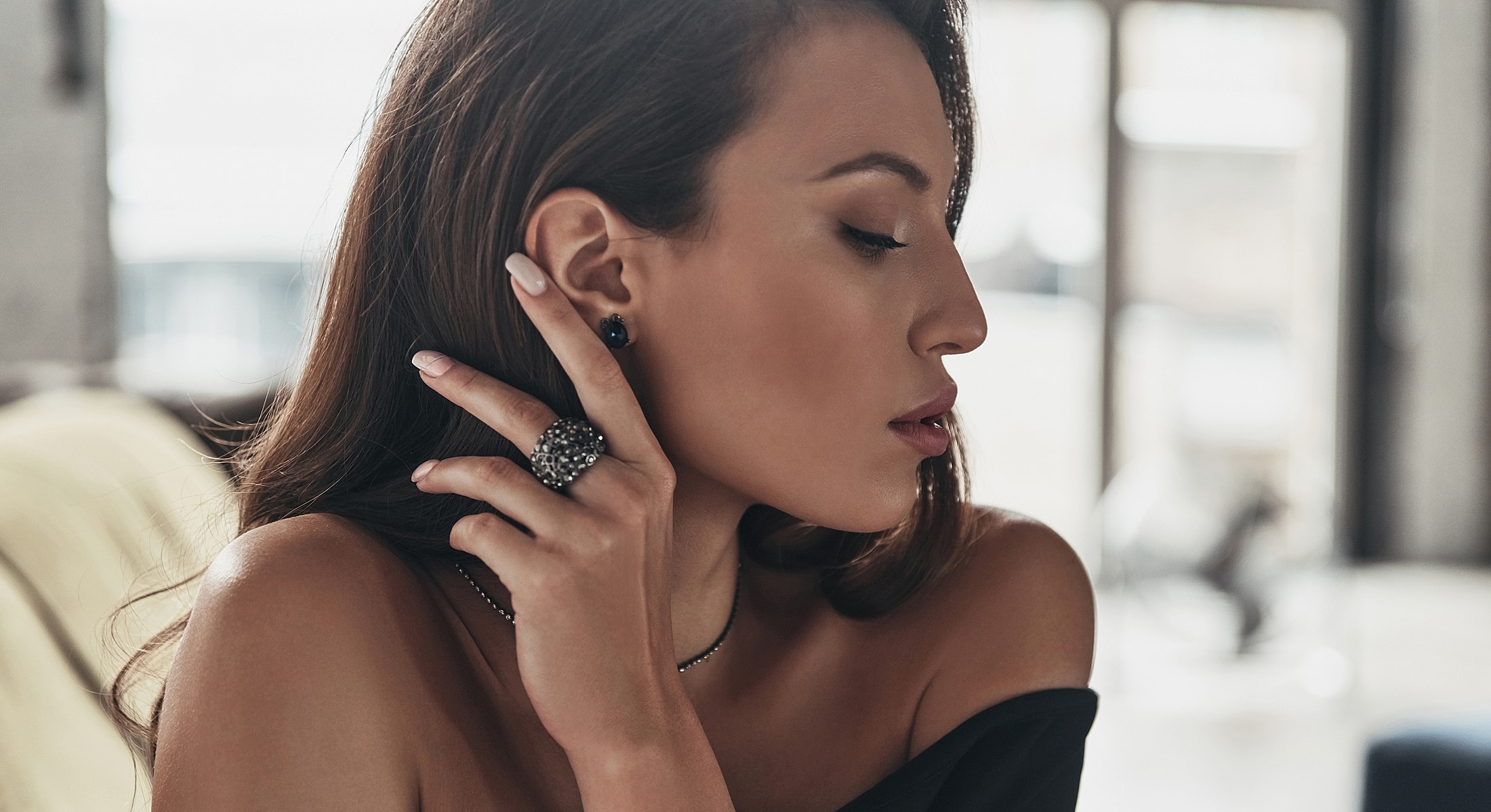 Woman wearing elegant jewelry, side profile shot.