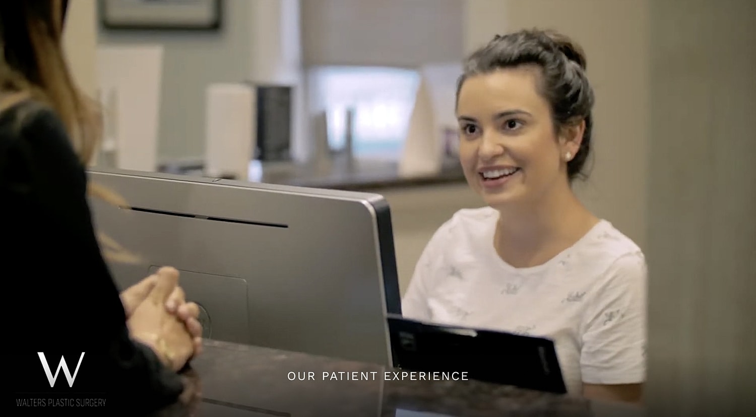 Smiling receptionist at a plastic surgery office.